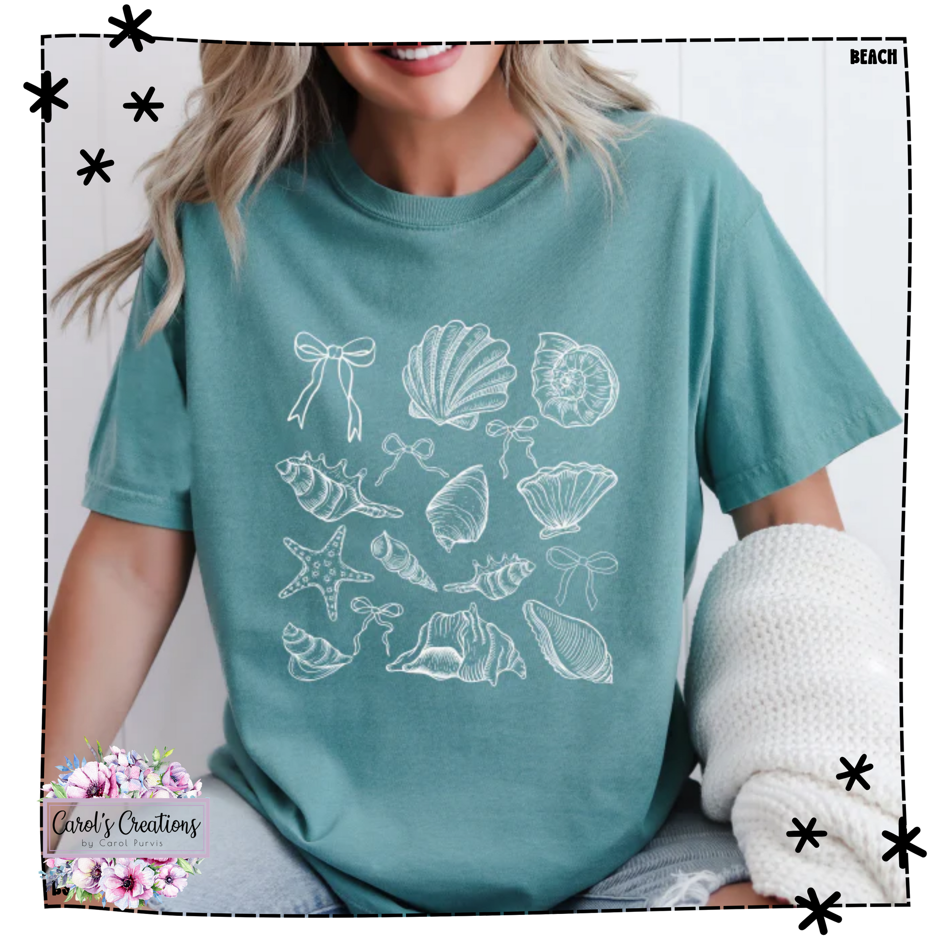 Person wearing a teal t-shirt with white shell designs on a light gray background