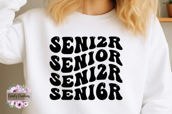 White sweatshirt with 'SENIOR' text in black, worn by a person.