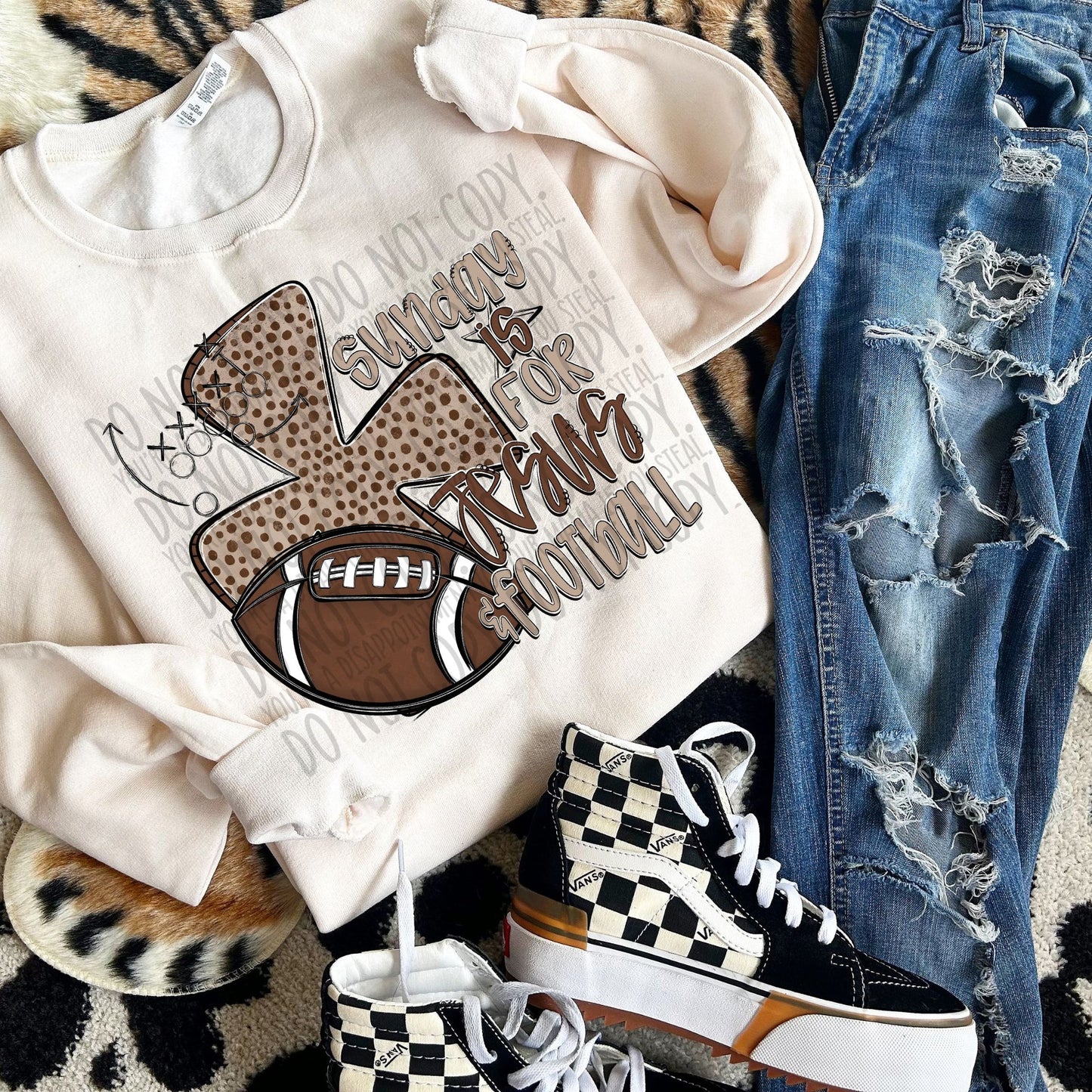 White sweatshirt with football graphic, jeans, and checkered sneakers on a patterned surface