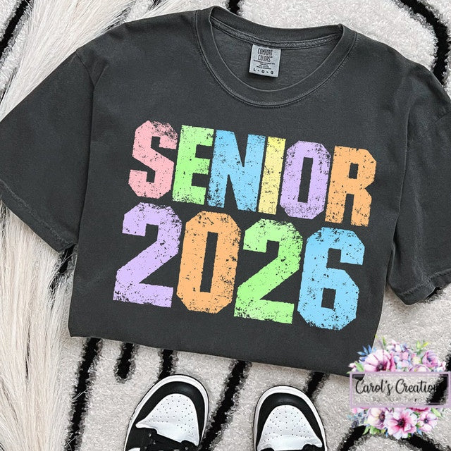 Black t-shirt with 'Senior 2026' text in colorful letters on a textured surface.